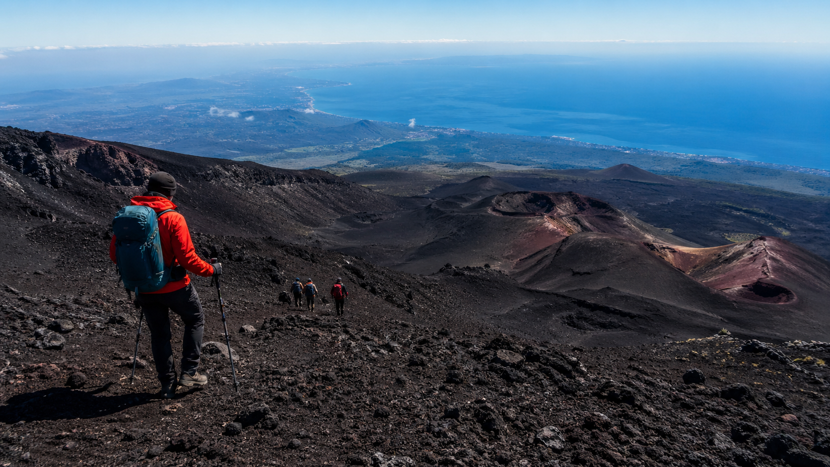 Hiker Exploring Volcanic Landscape Toward Ocean